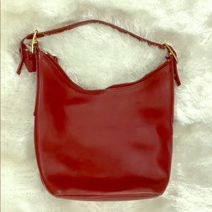 Red Coach purse over shoulder